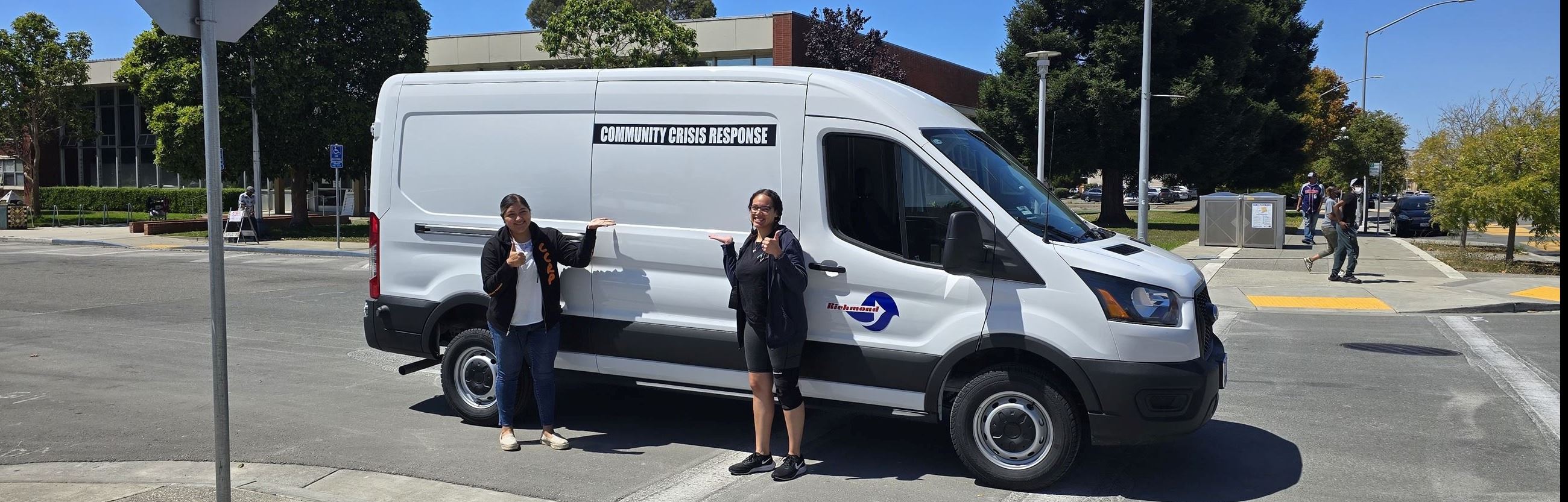 White Van with two people standing in front,with City of Richmond and Community Crisis Response Logo